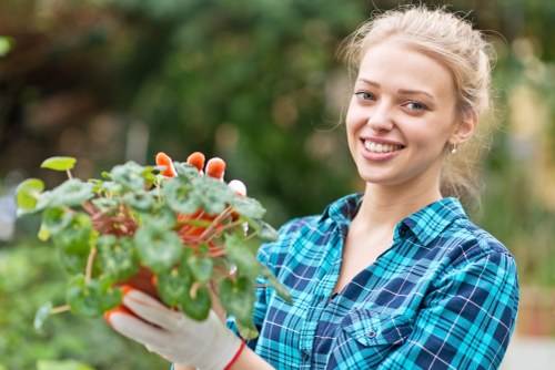 Team member managing green waste at a garden site in Purley